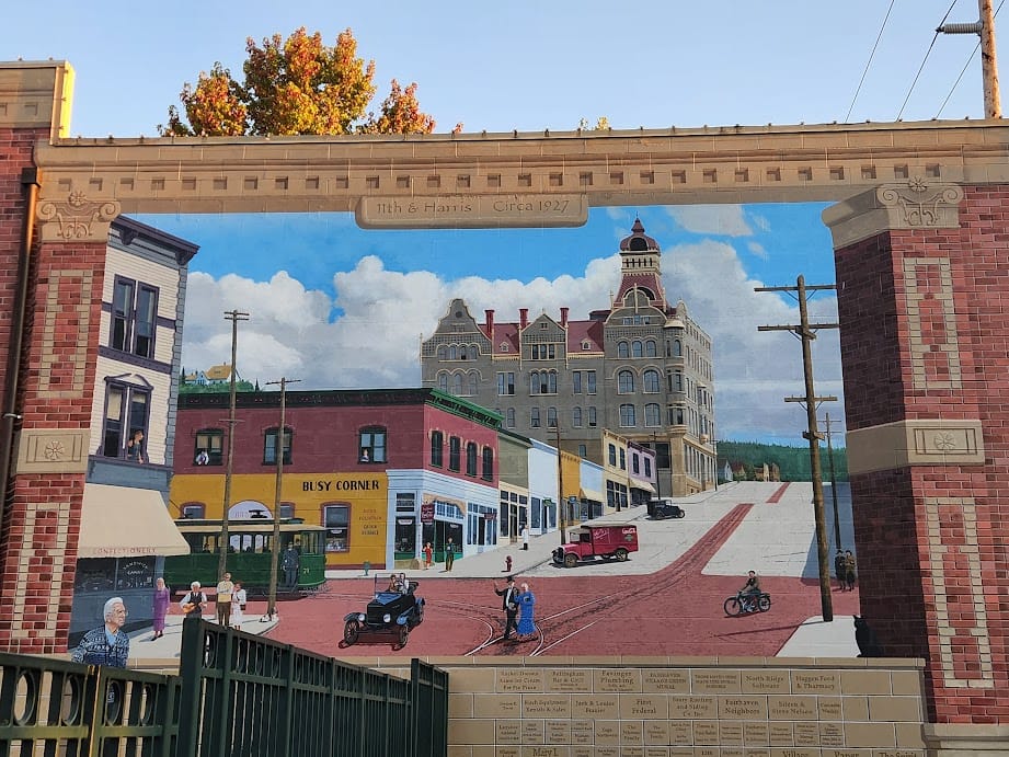 A mural depicting a street scene from Fairhaven circa 1927, with commercial buildings and the former Fairhaven Hotel building and its Flemish Revival turret.