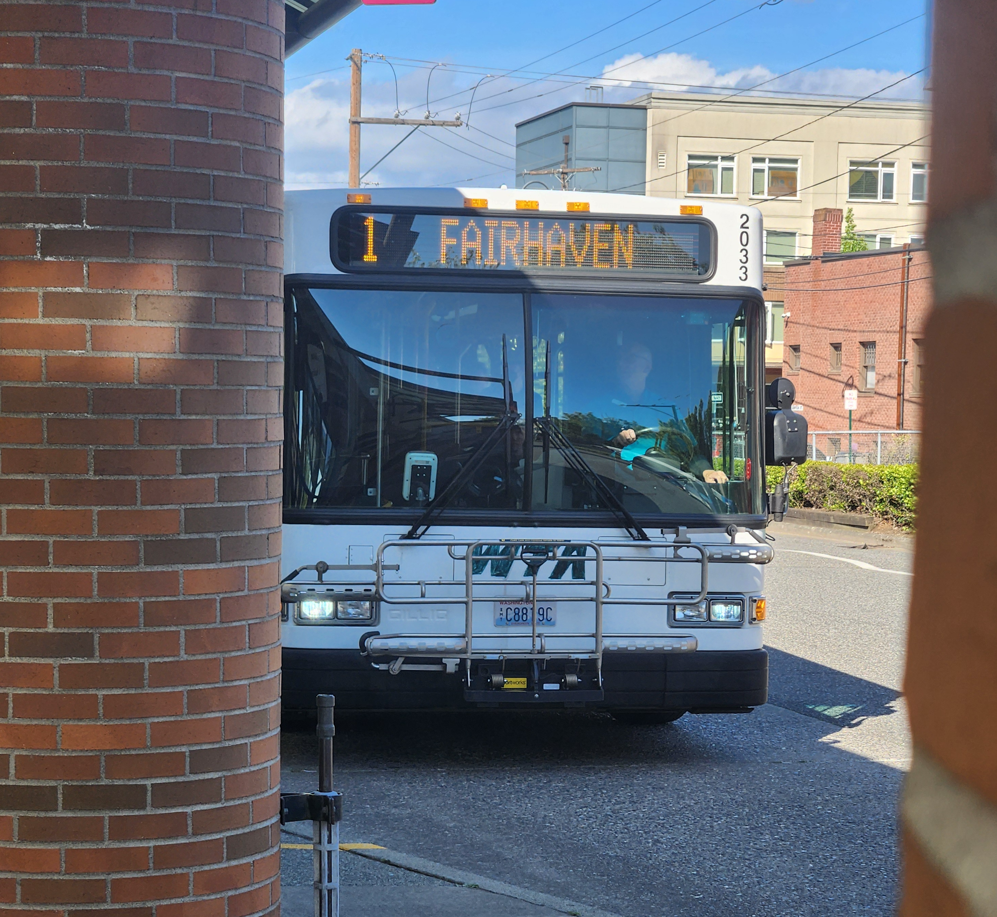 A WTA bus for Route 1 / Fairhaven pulls into a bus bay at Bellingham Station.
