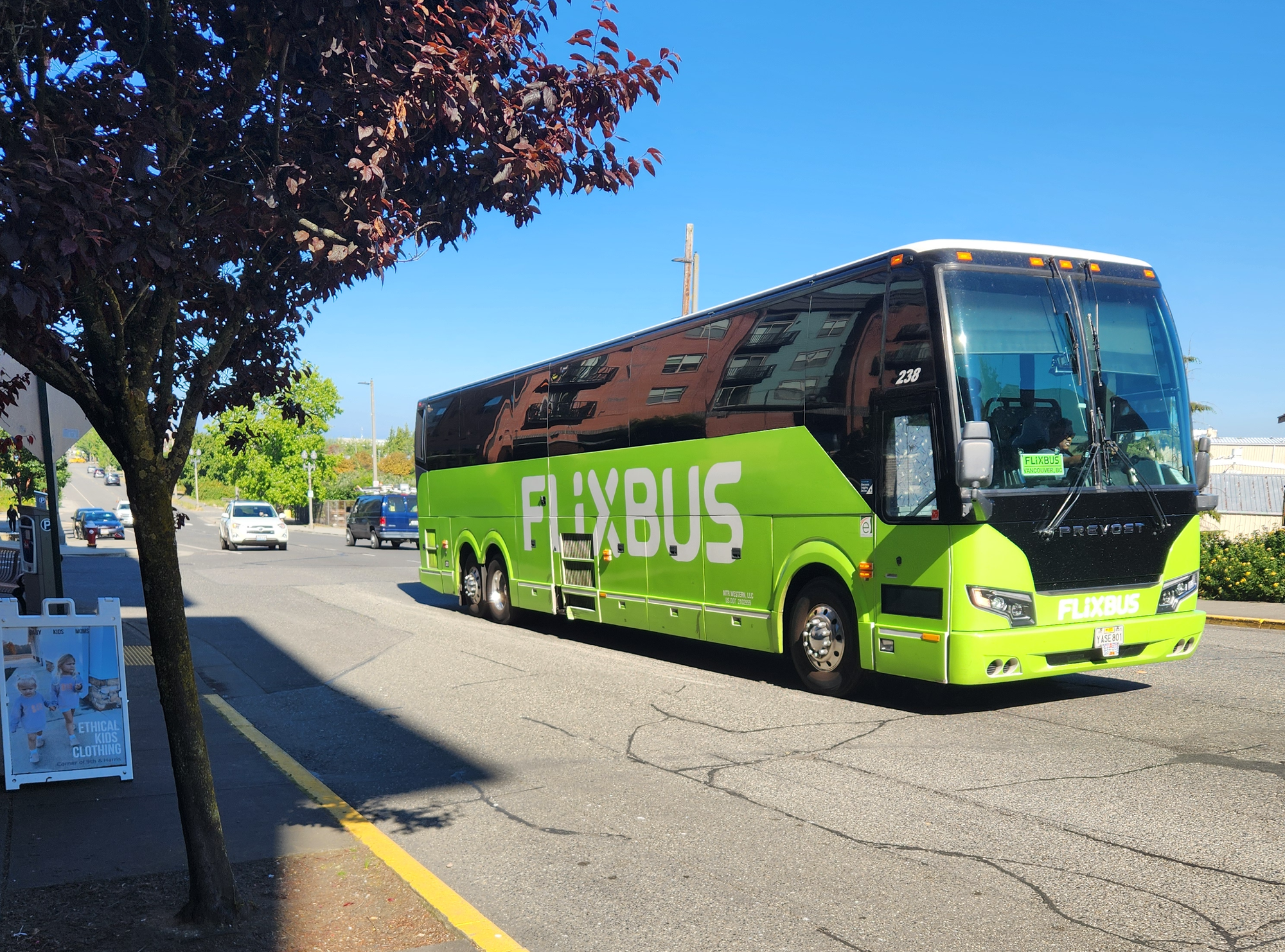 A green Flixbus on a street.