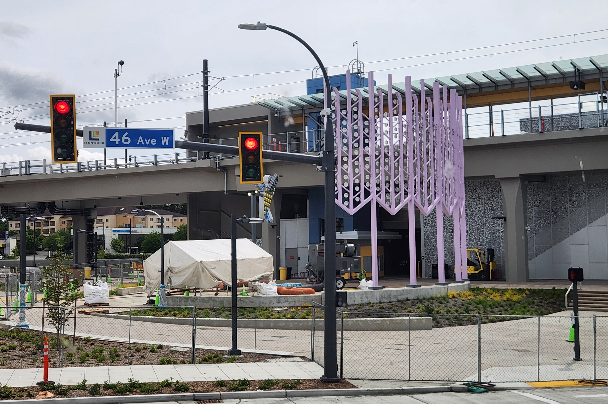 The elevated Lynnwood City Center Station with public art on the plaza.