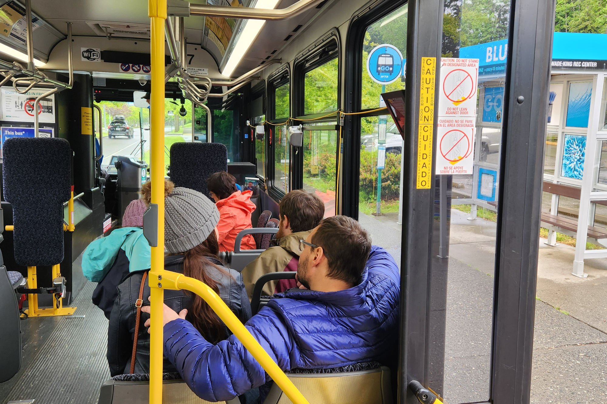 Passengers sit on a bus.