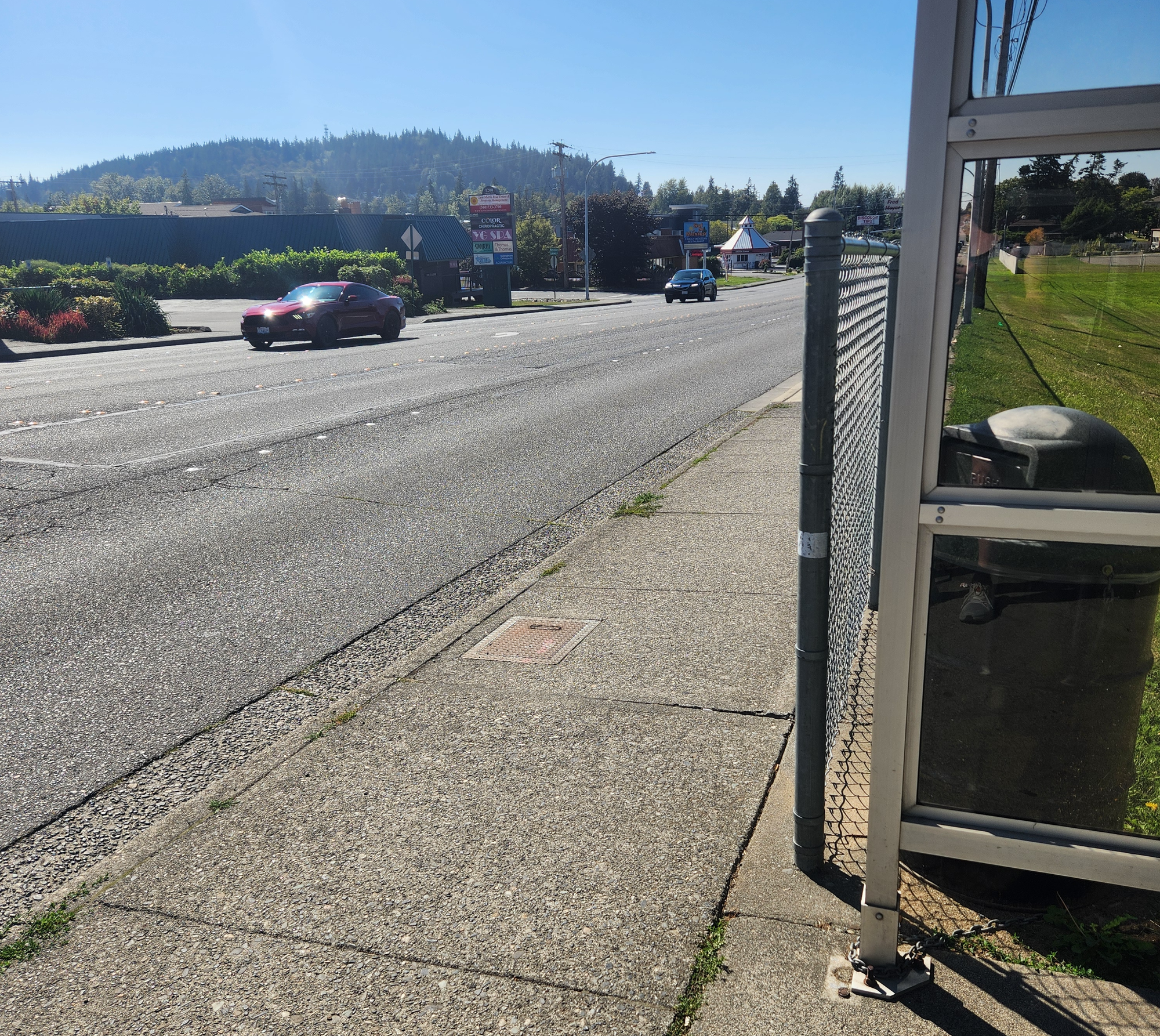 An expanse of asphalt roadway with two lanes traveling in either direction.