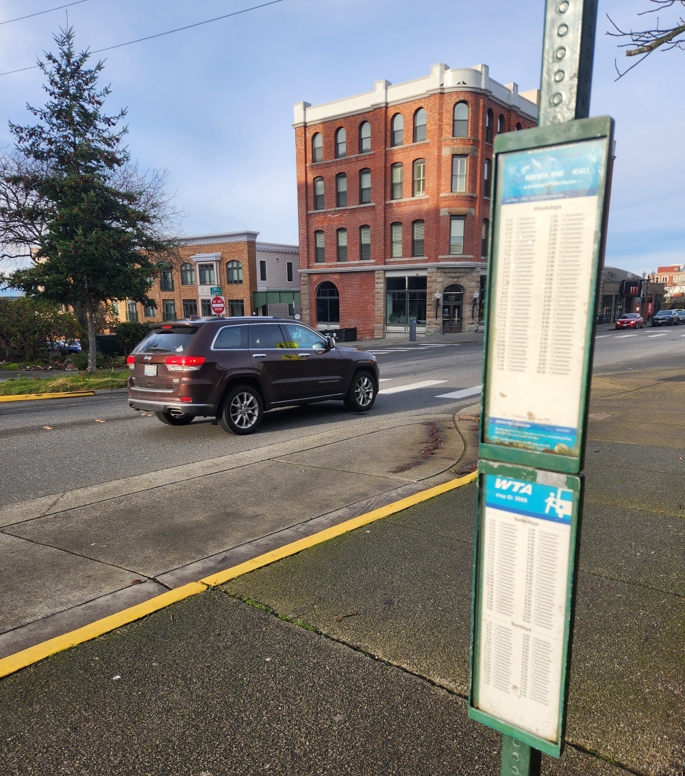 A daylight view of a very dimly lit crosswalk in Fairhaven, at 12th Street & McKenzie Avenue, where the City of Bellingham has proposed a new flashing crosswalk beacon, which will help improve safety accessing the WTA bus stops adjacent to Haggen and the Bellingham Housing Authority's Chuckanut Square apartments