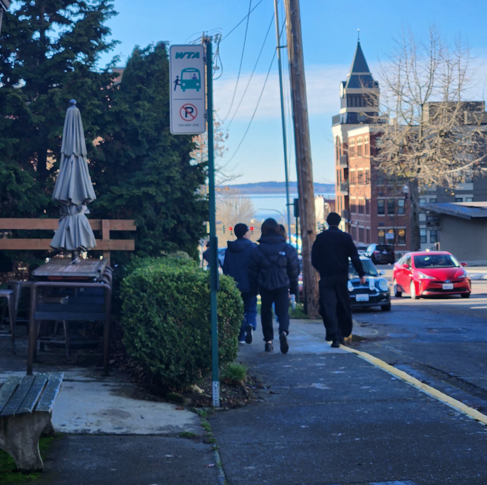 A WTA bus stop with the clocktower of the Fairhaven Tower building in the background.