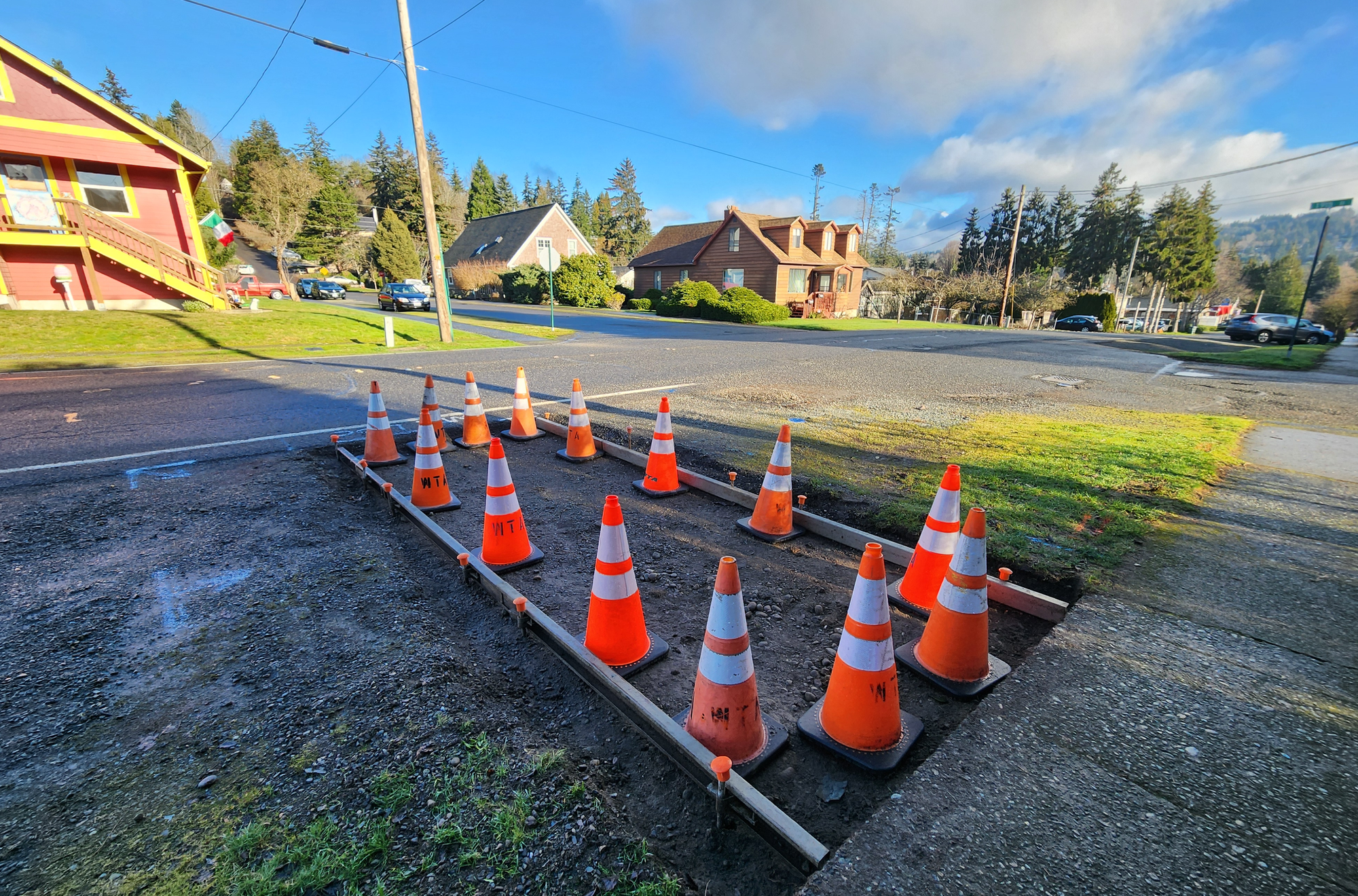 Orange cones mark off a section of sidewalk.