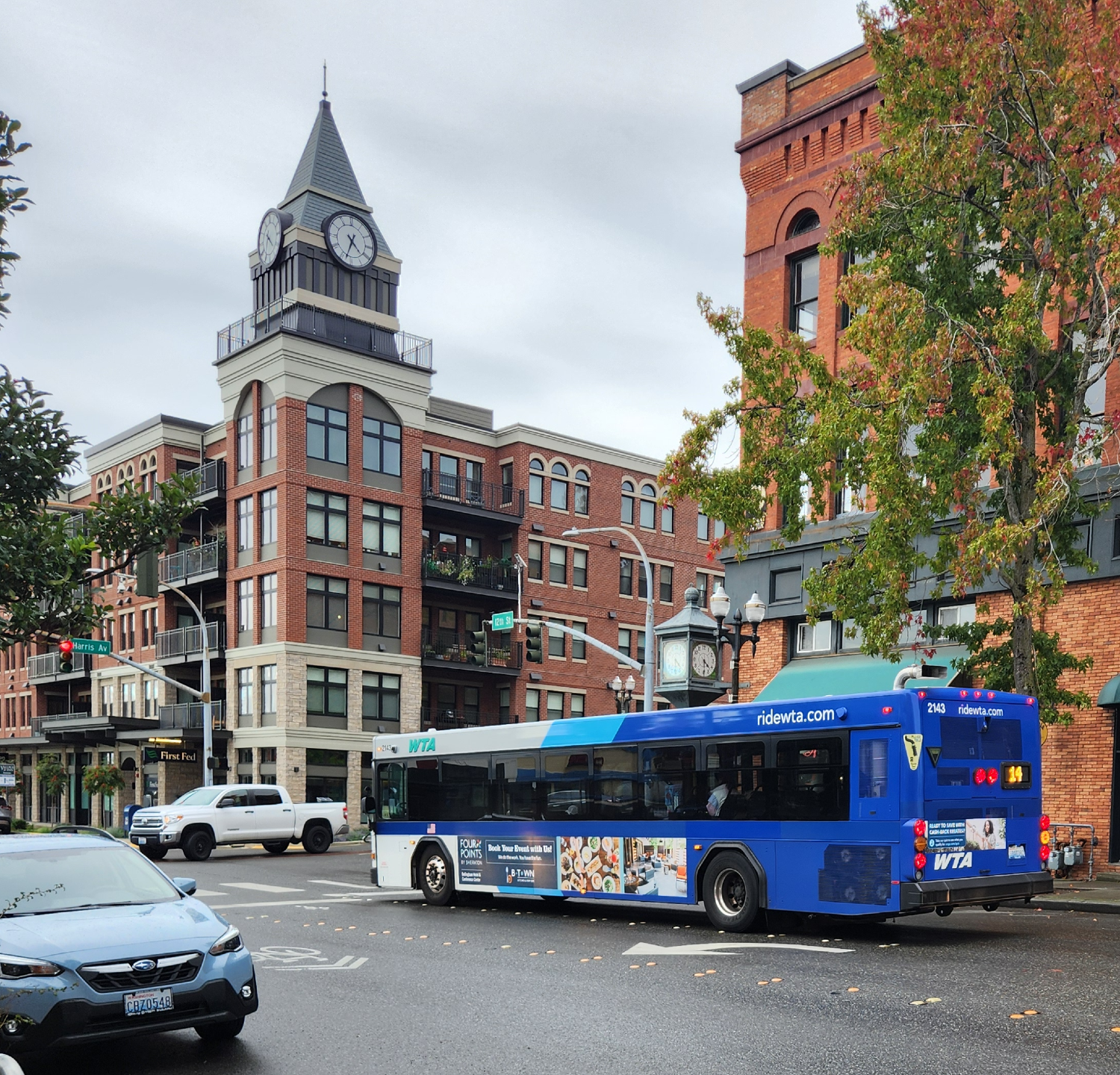 A WTA bus gets ready to turn at an intersection in a commercial district.